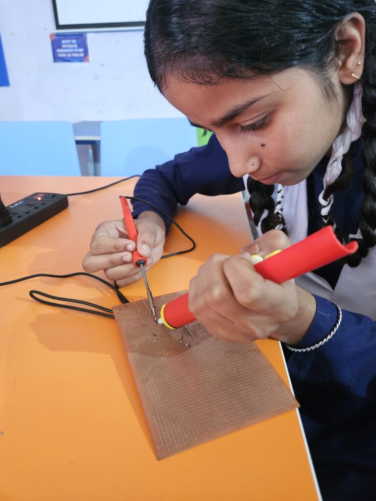 student using desoldering pump