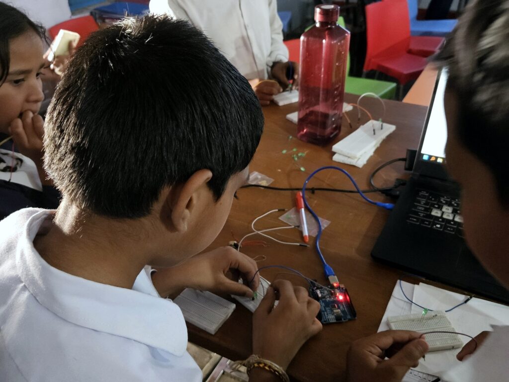 student coding on US sensor